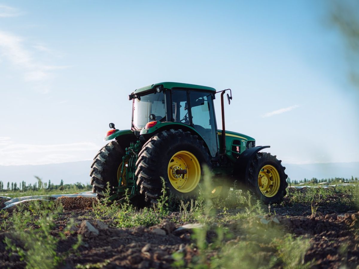 Agricultural machinery parked at the edge of a cultivated field