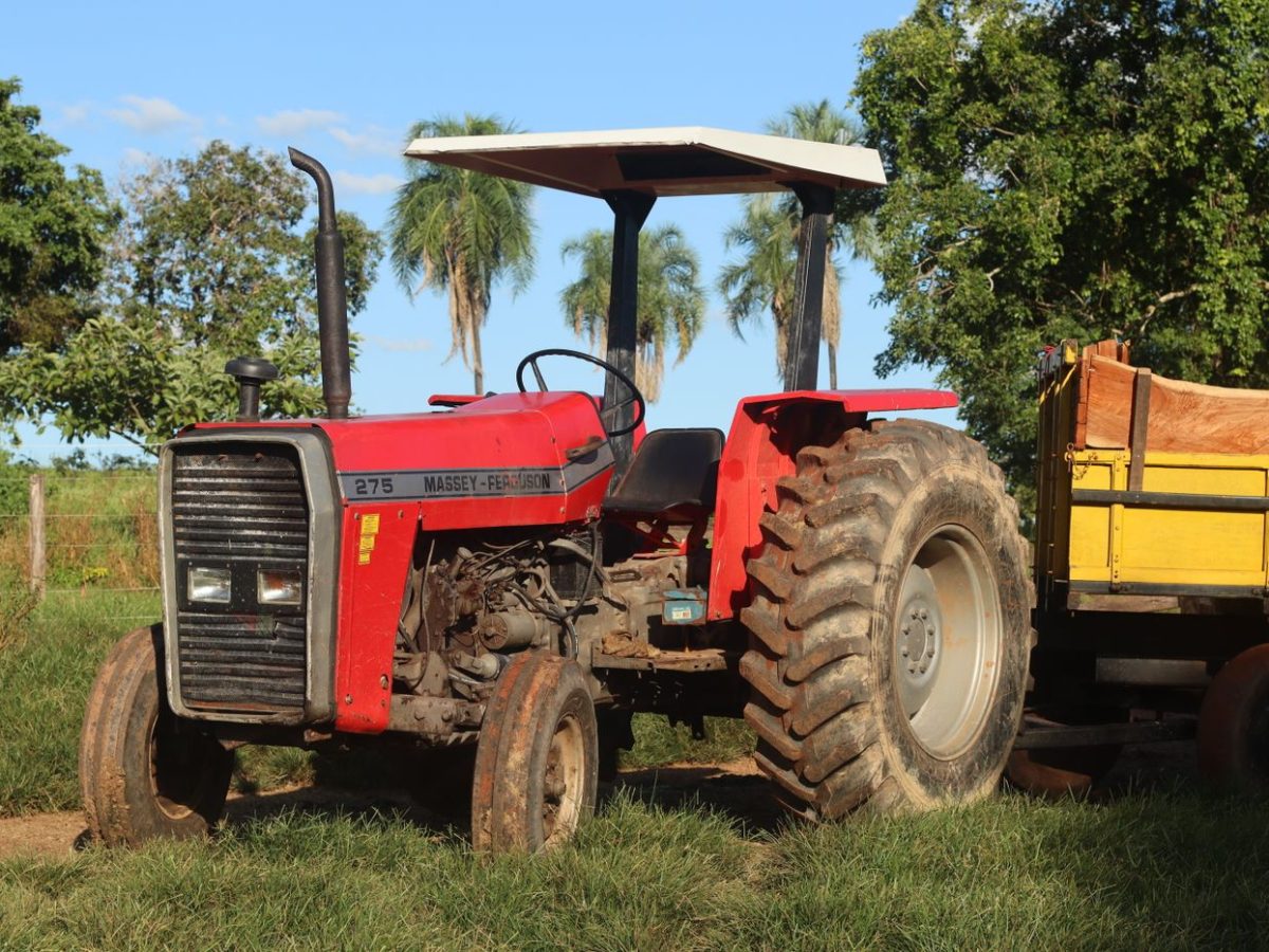 Tractor hauling a loaded agricultural trailer along a field track
